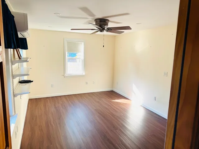wooden floor in an empty room with a window