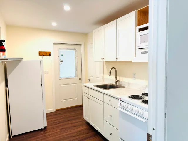 a kitchen with a sink and a refrigerator