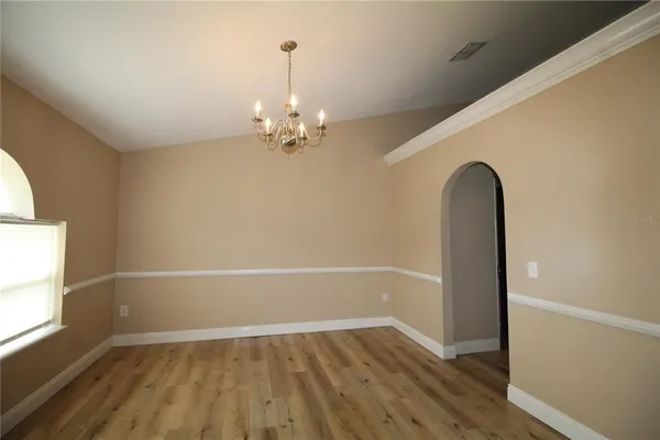 a view of a room with a window and a ceiling fan