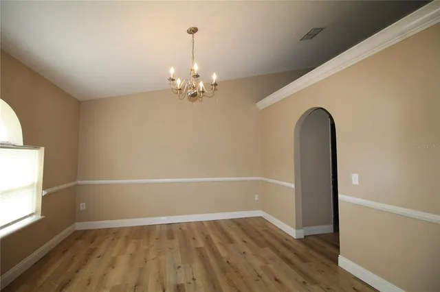 a view of a room with a window and a ceiling fan