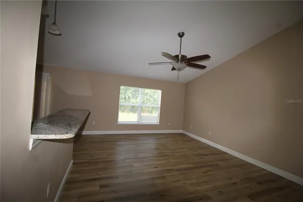 a view of a kitchen counter space and wooden floor