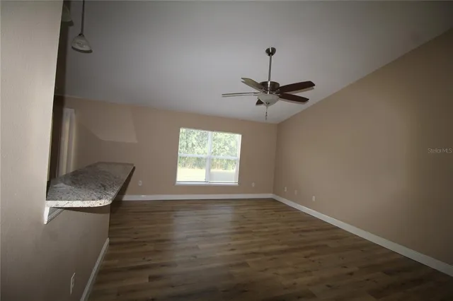 a view of a kitchen counter space and wooden floor