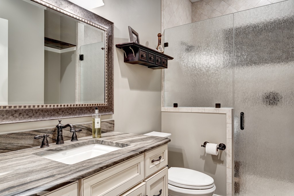 164 Beach Street Sharon, MA 02067 - Photo 14 of 30 a bathroom with a granite countertop sink toilet a mirror and shower