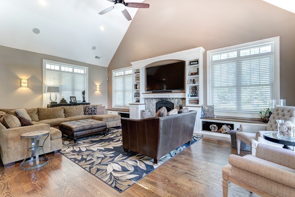 164 Beach Street Sharon, MA 02067 - Photo 6 of 30 a living room with furniture a flat screen tv and a fireplace