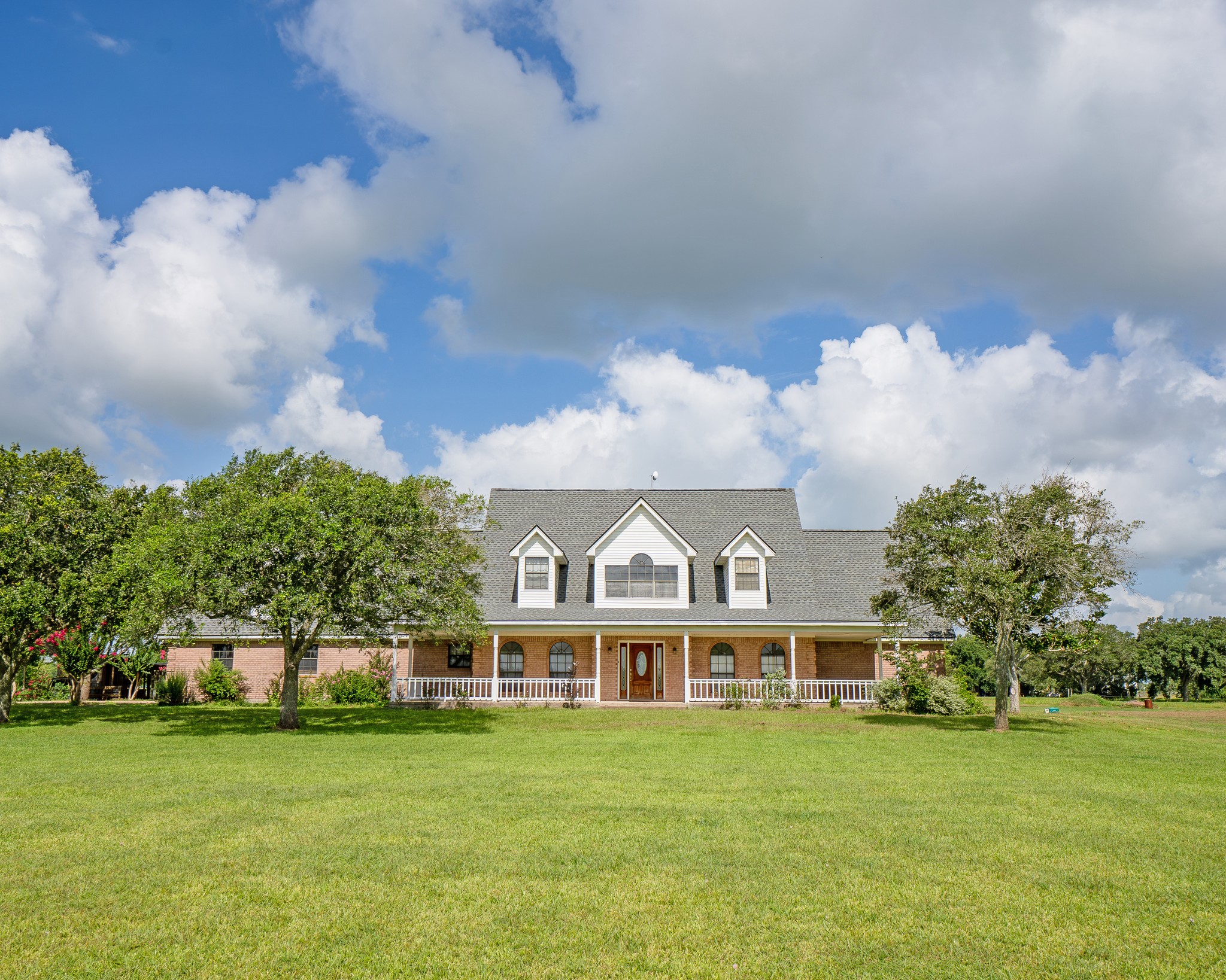a front view of a house with a garden