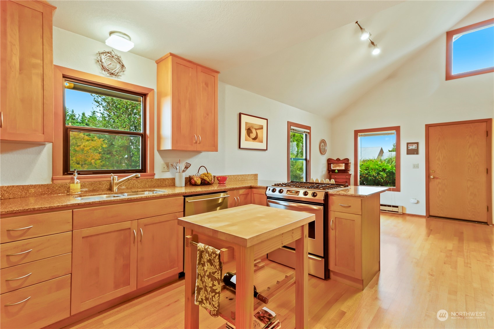 15916 Kamb Road Mount Vernon, WA 98273 - Photo 12 of 29 a kitchen with a stove a sink a dining table and chairs