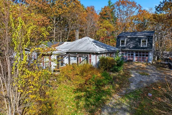 a backyard of a house with table and chairs