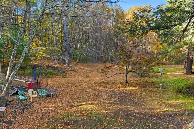 a backyard of a house with table and chairs
