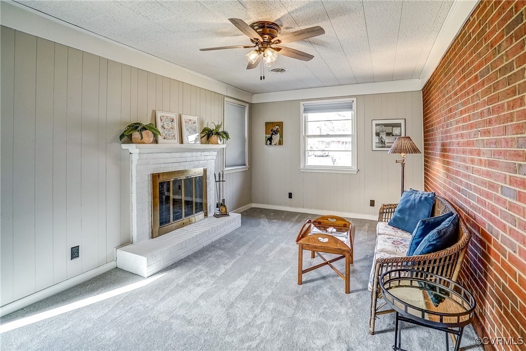 2703 Omega Road Henrico, VA 23228 - Photo 16 of 43 Sitting room with carpet floors, brick wood burnin