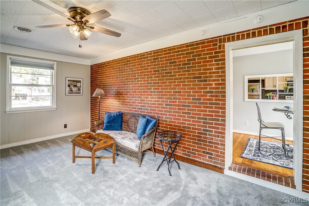 2703 Omega Road Henrico, VA 23228 - Photo 17 of 43 Living area with carpet floors, brick wall, visibl