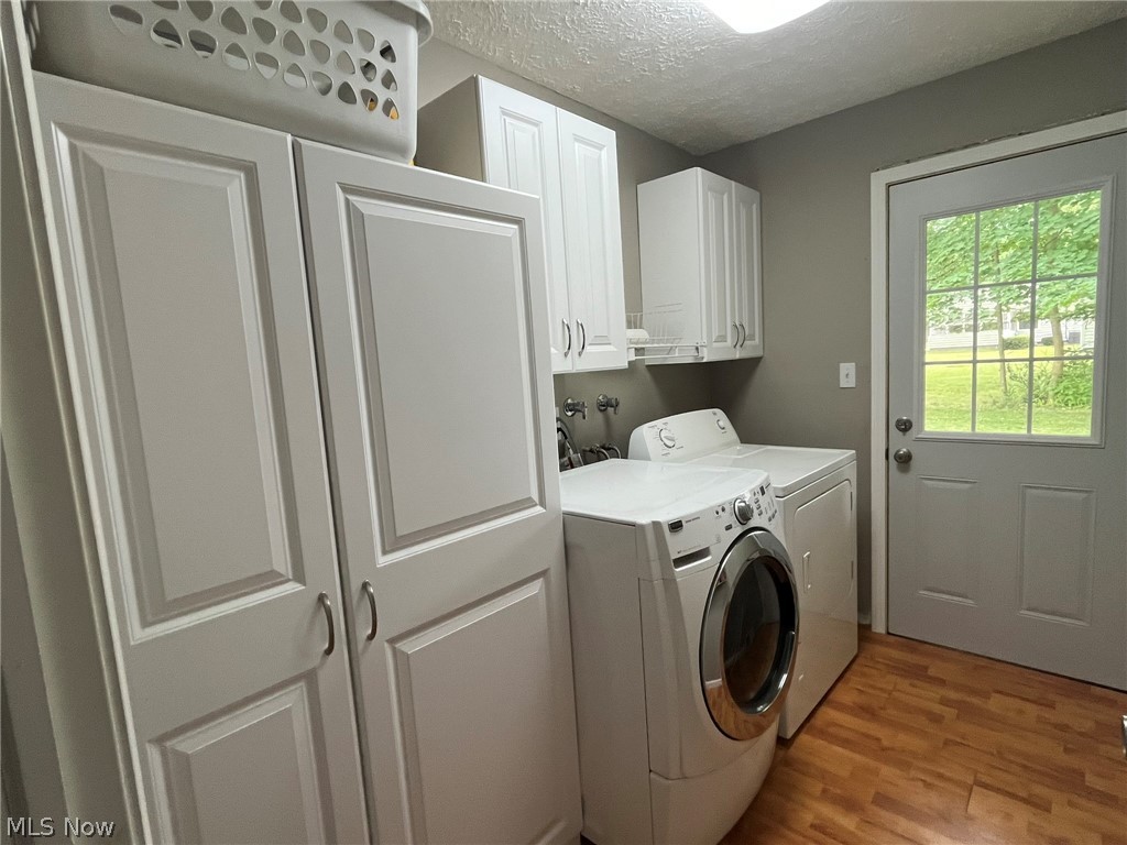 1166 Hampton Road Kent, OH 44240 - Photo 10 of 26 1st floor Laundry room featuring built in cabinets and a door to the backyard