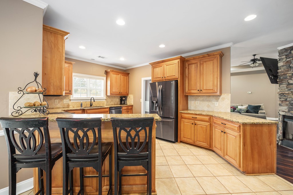 235 Voorhees Road Hamilton, GA 31811 - Photo 14 of 36 a kitchen with stainless steel appliances granite countertop a stove a sink dishwasher and a refrigerator