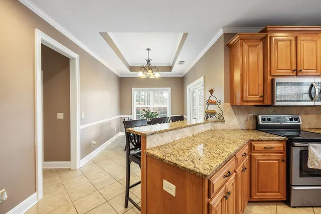 a kitchen with stainless steel appliances granite countertop a refrigerator and a sink