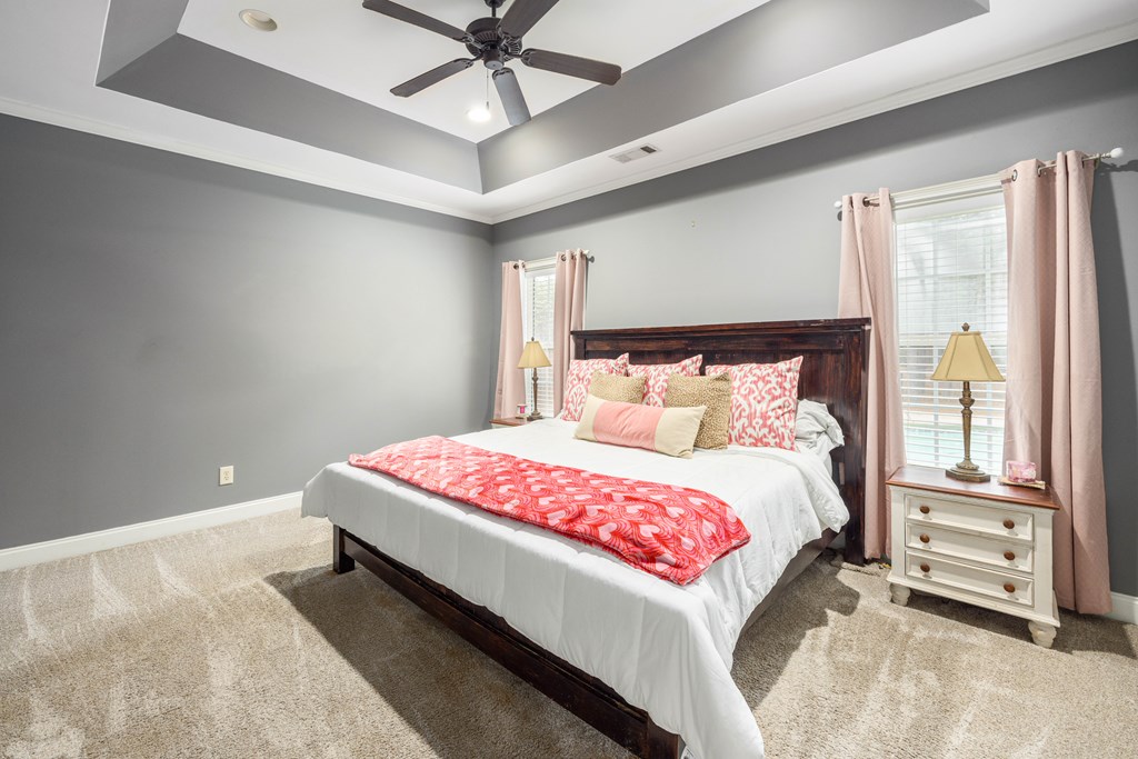 235 Voorhees Road Hamilton, GA 31811 - Photo 22 of 36 a bedroom with a bed and a chandelier