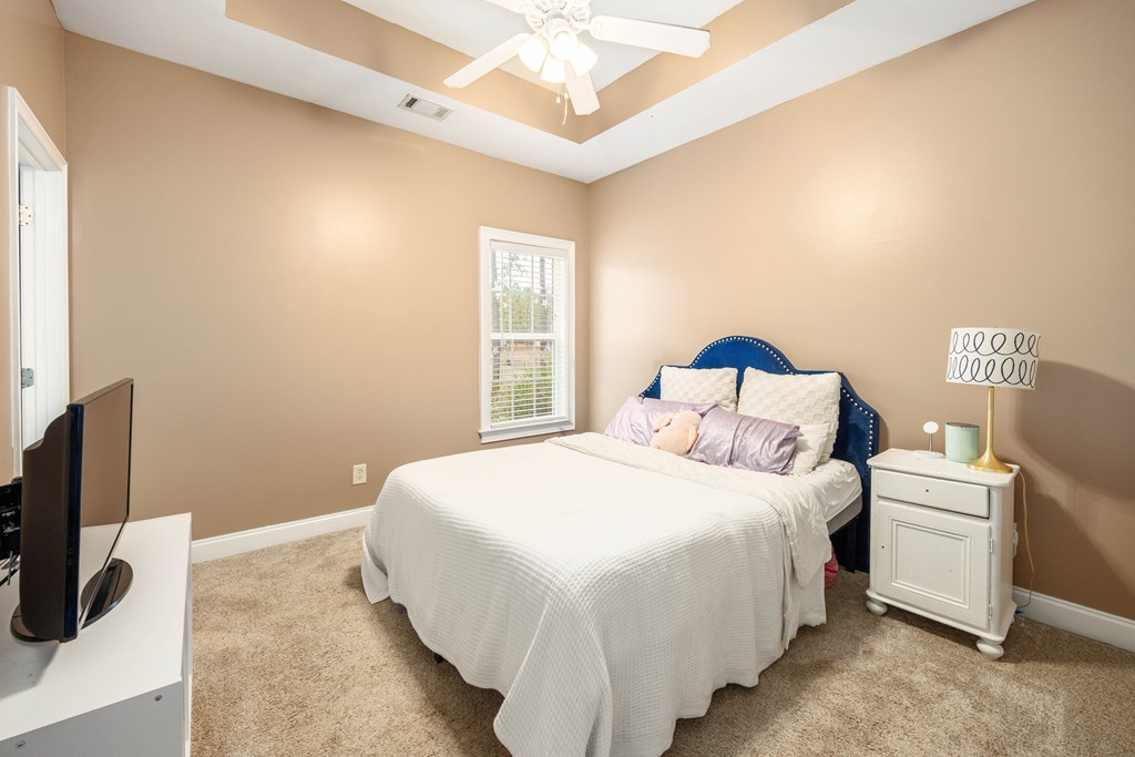 235 Voorhees Road Hamilton, GA 31811 - Photo 26 of 36 a bedroom with a bed and a flat screen tv