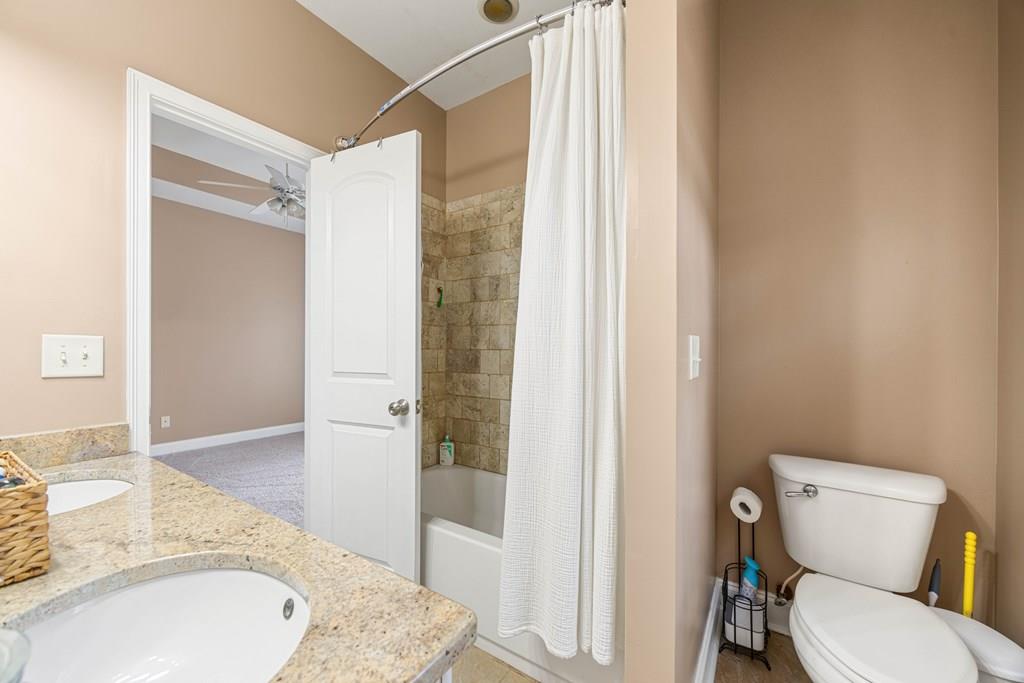 235 Voorhees Road Hamilton, GA 31811 - Photo 28 of 36 a bathroom with a granite countertop sink toilet and shower