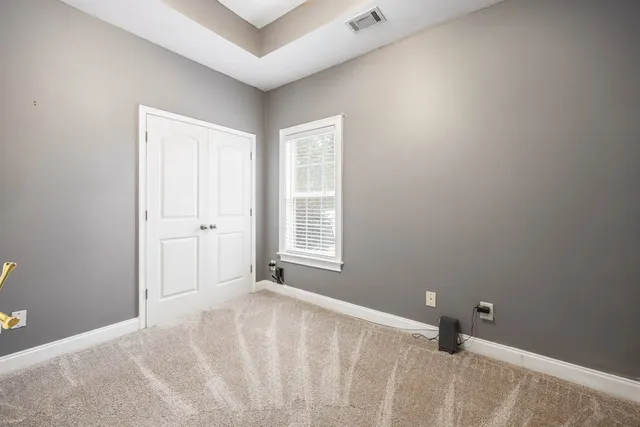 a bathroom with a granite countertop sink a toilet and shower