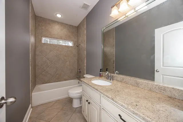 a view of swimming pool with seating area and trees around