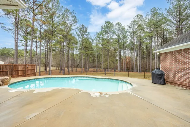 a view of a house with swimming pool and a porch with furniture