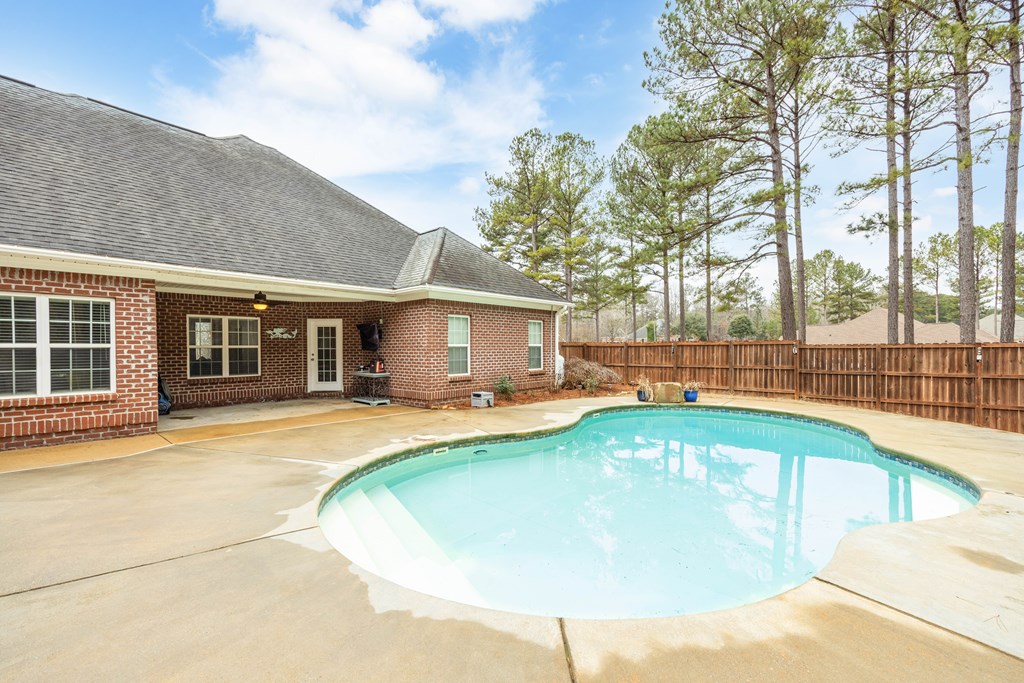235 Voorhees Road Hamilton, GA 31811 - Photo 33 of 36 a view of a house with swimming pool and a porch with furniture