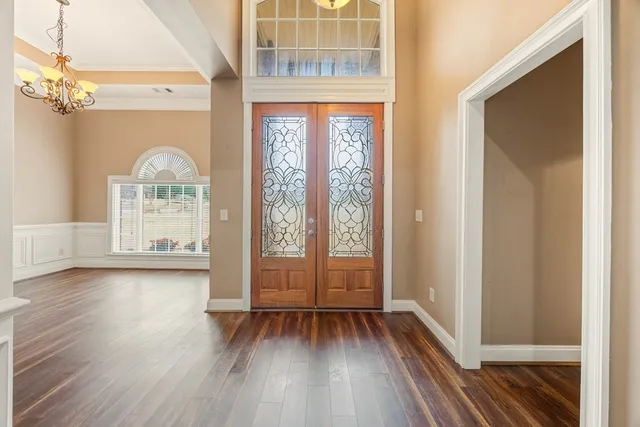 a living room with furniture and a chandelier