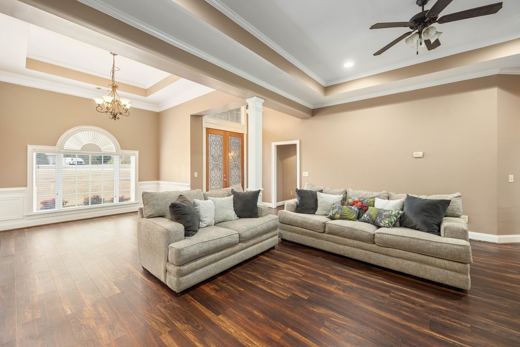 235 Voorhees Road Hamilton, GA 31811 - Photo 6 of 36 a living room with furniture and a chandelier