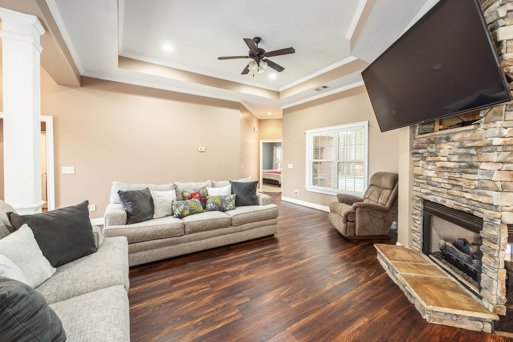 235 Voorhees Road Hamilton, GA 31811 - Photo 7 of 36 a living room with furniture a fireplace and a flat screen tv