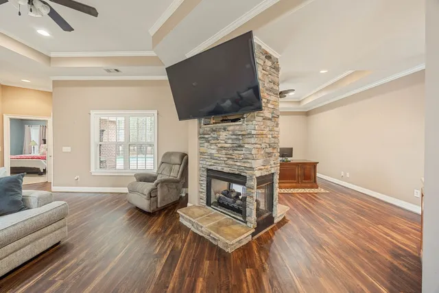 a living room with furniture a fireplace and a flat screen tv