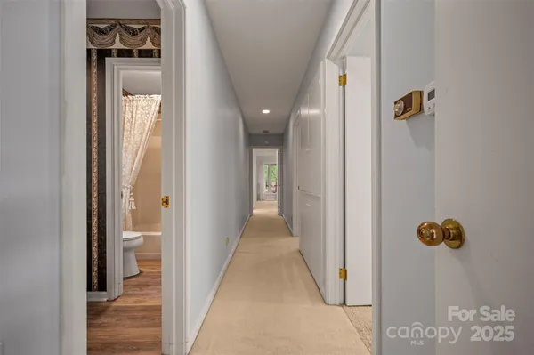 a view of a hallway with wooden floor