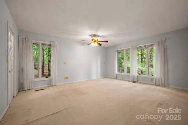 a view of a livingroom with a ceiling fan and window