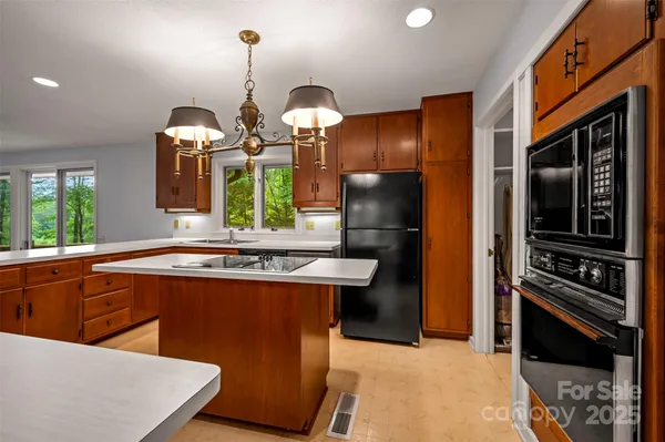 a kitchen with stainless steel appliances granite countertop a stove a refrigerator and a sink