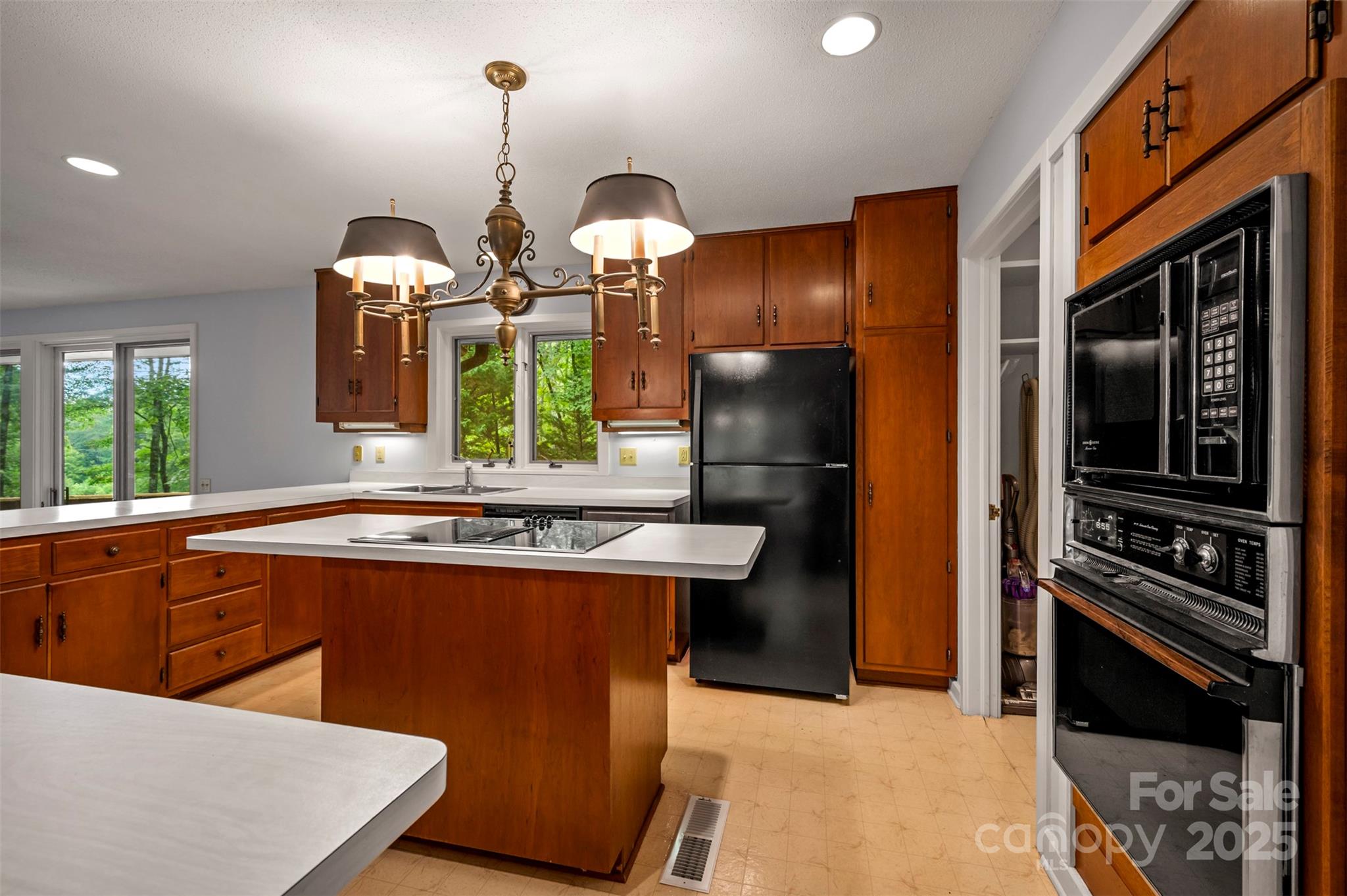 106 Bluebird Lane Tryon, NC 28782 - Photo 5 of 26 a kitchen with stainless steel appliances granite countertop a stove a refrigerator and a sink