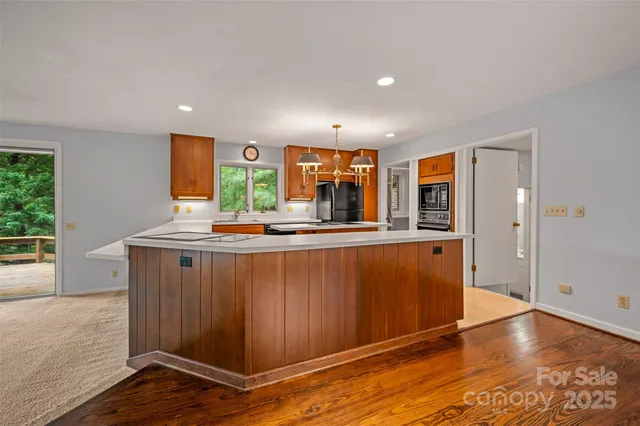 a kitchen with stainless steel appliances granite countertop a refrigerator and a stove top oven