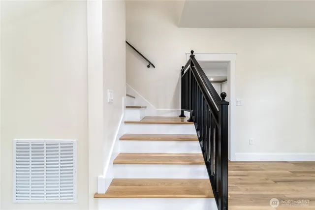 a view of hallway with wooden floor
