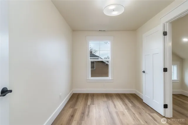 a view of a room with wooden floor and fan