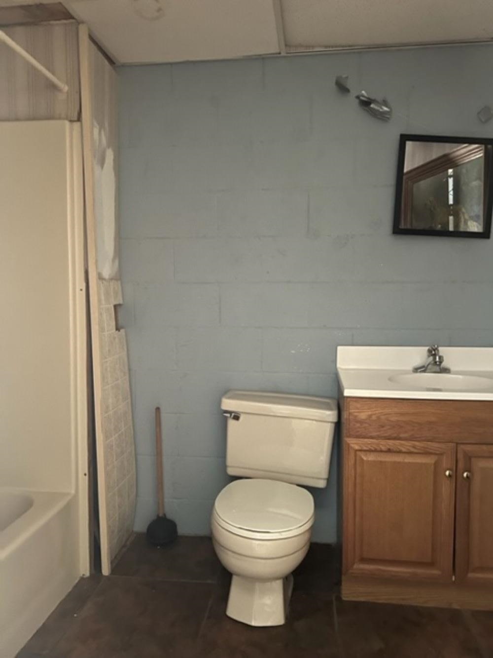 170 Ivy Lane Adamsville, TN 38310 - Photo 21 of 34 a bathroom with a toilet sink and mirror