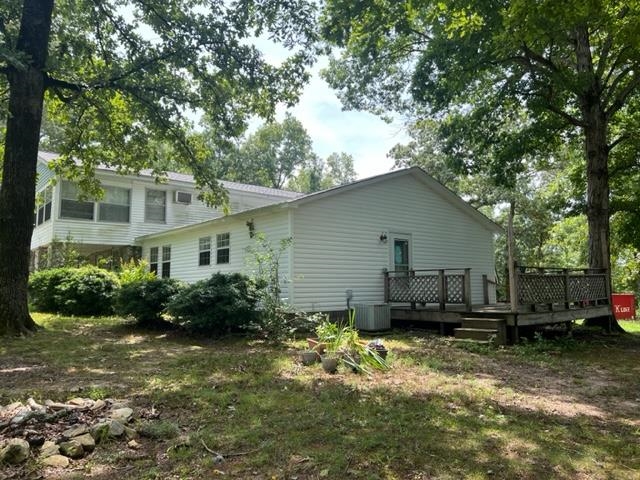 170 Ivy Lane Adamsville, TN 38310 - Photo 24 of 34 a backyard of a house with potted plants and large tree