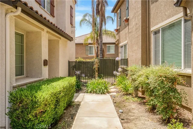 a view of a pathway both side of the house