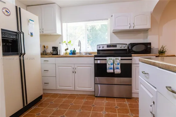 a kitchen with stainless steel appliances a stove a sink and a refrigerator