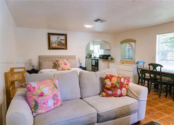 a living room with furniture and painting on the wall