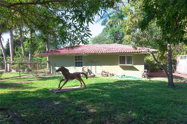 a view of a house with a yard porch and sitting area