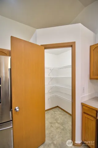 a view of kitchen with microwave and refrigerator