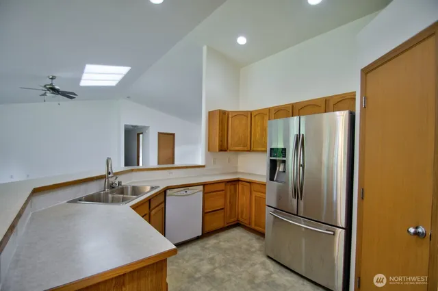 a kitchen with granite countertop cabinets sink and window