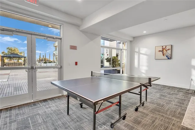 a kitchen with stainless steel appliances granite countertop a sink stove refrigerator and cabinets