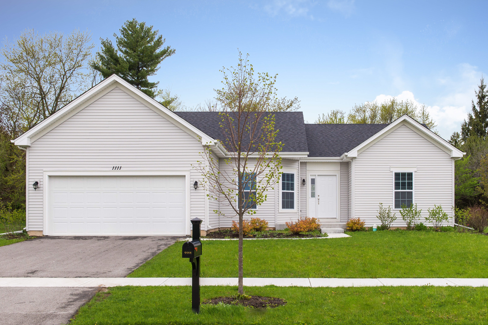 1111 Bailey Road Sycamore, IL 60178 - Photo 1 of 32 a view of a white house next to a yard and trees