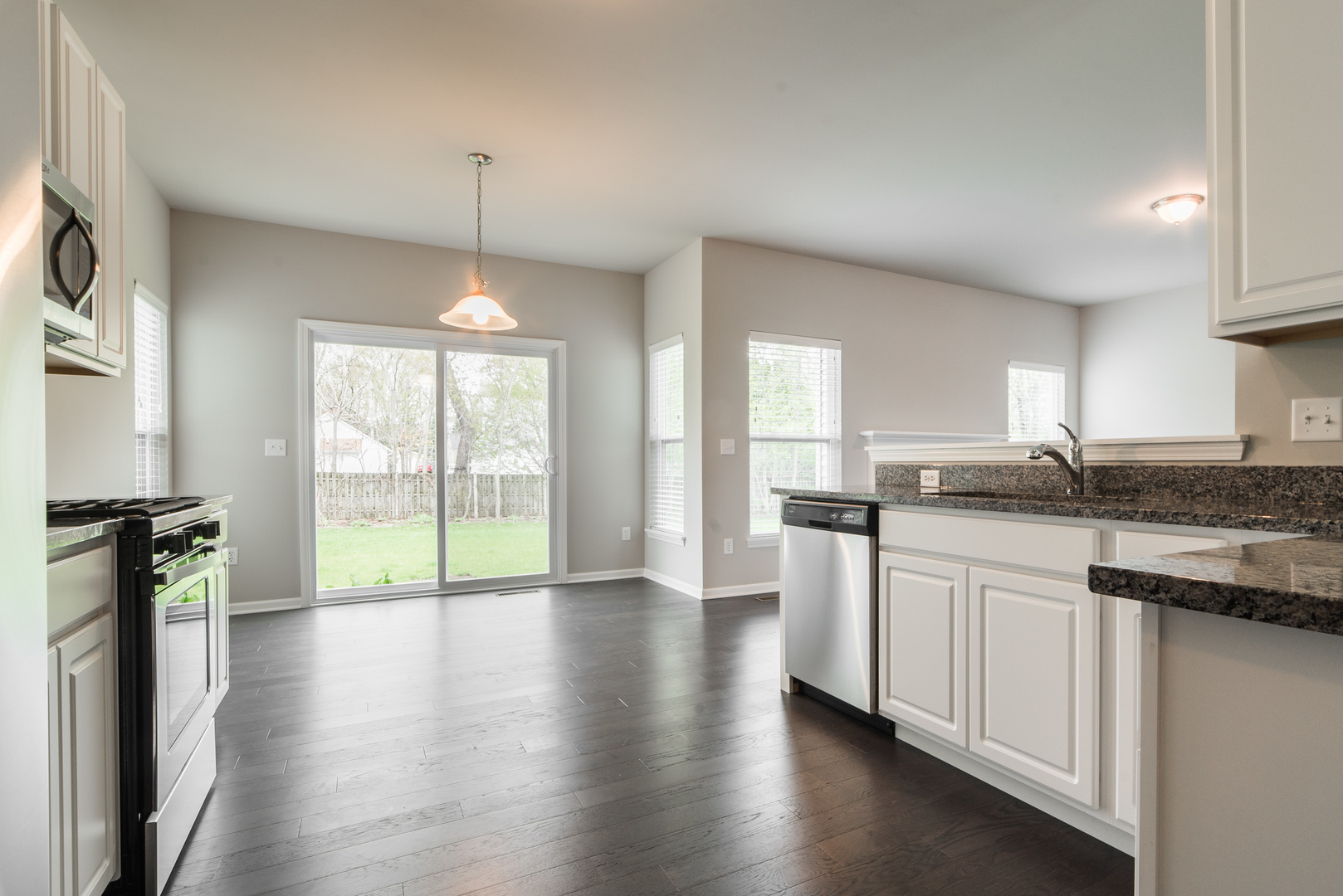 1111 Bailey Road Sycamore, IL 60178 - Photo 12 of 32 a kitchen with stainless steel appliances granite countertop a stove a sink dishwasher a refrigerator with wooden floor and cabinets
