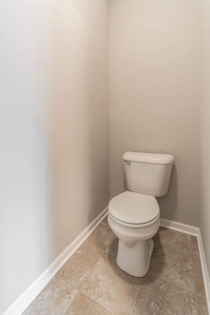 1111 Bailey Road Sycamore, IL 60178 - Photo 18 of 32 a white toilet sitting next to a white wall