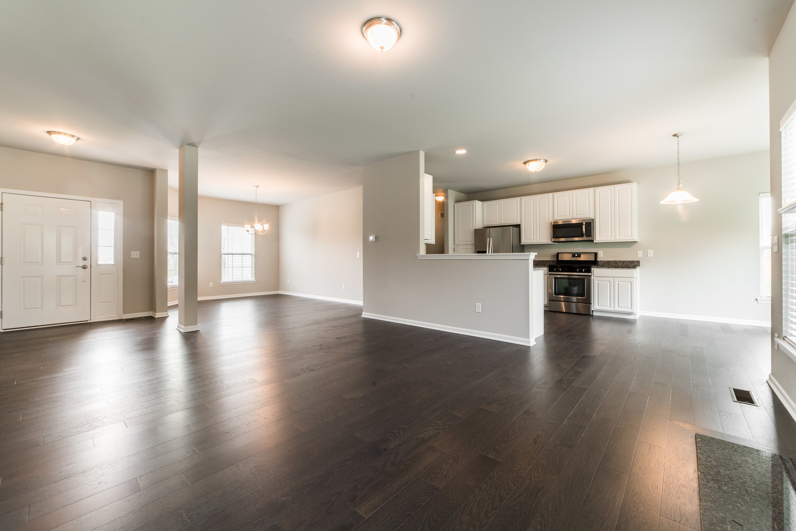 1111 Bailey Road Sycamore, IL 60178 - Photo 4 of 32 a view of a big room with wooden floor and a kitchen