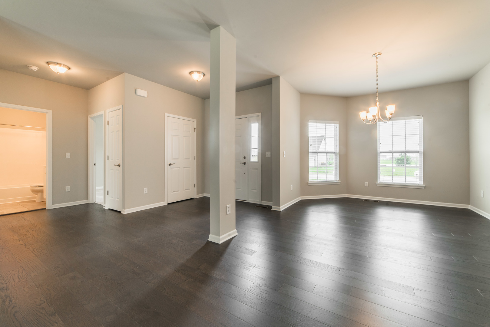 1111 Bailey Road Sycamore, IL 60178 - Photo 5 of 32 an empty room with wooden floor and windows