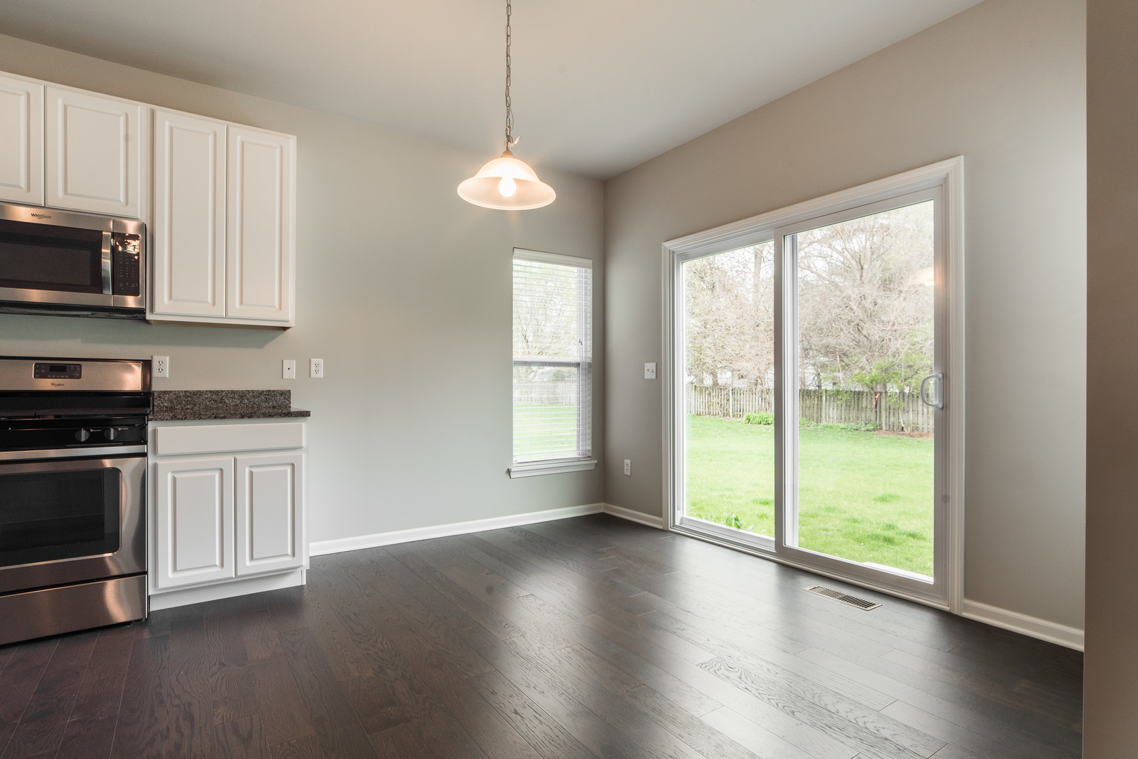1111 Bailey Road Sycamore, IL 60178 - Photo 7 of 32 a view of a kitchen with a stove wooden floor and a window